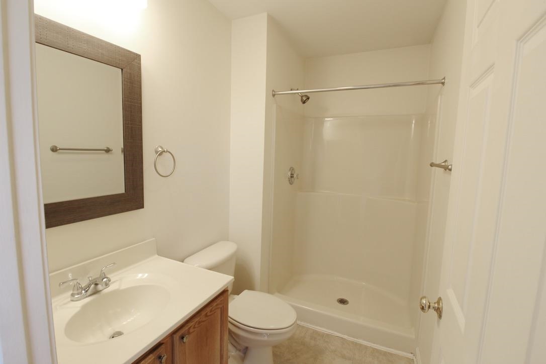 1026 Commercial Court Harrisonburg, VA 22802 - Photo 12 of 16 a bathroom with a sink a toilet and shower