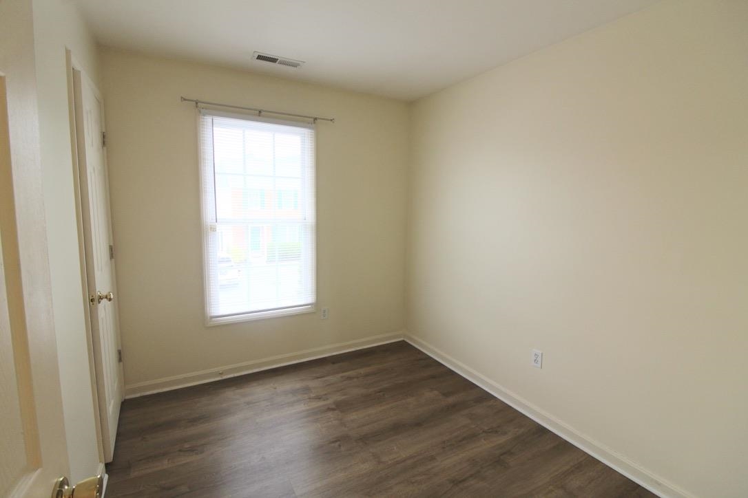 1026 Commercial Court Harrisonburg, VA 22802 - Photo 14 of 16 an empty room with wooden floor and windows