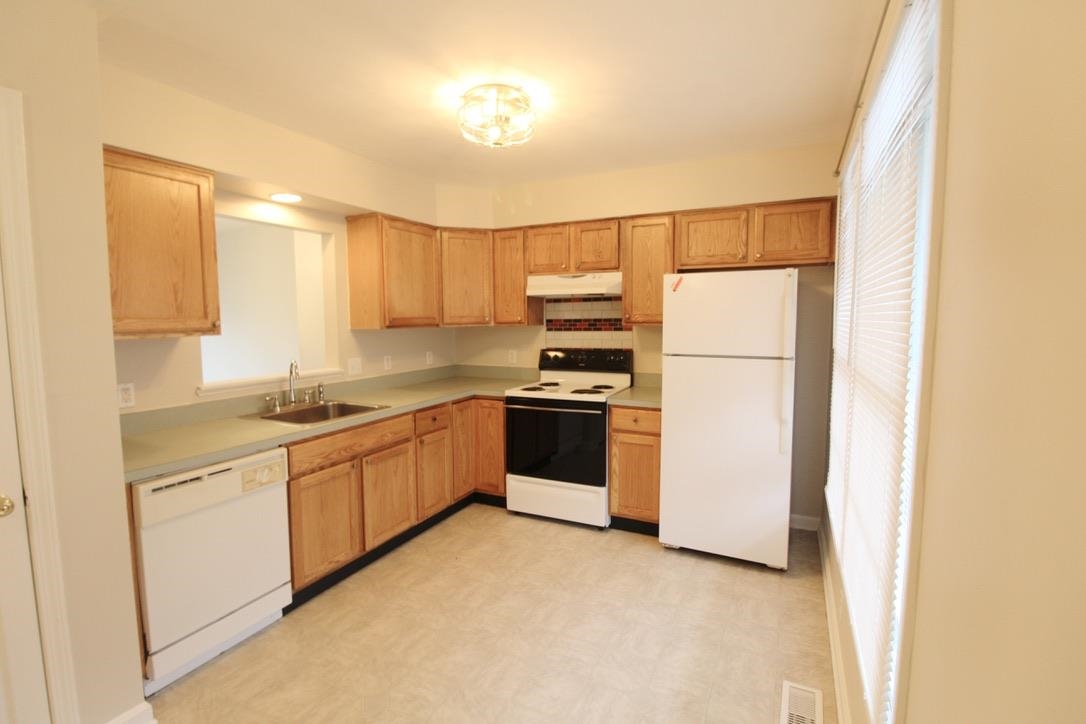 1026 Commercial Court Harrisonburg, VA 22802 - Photo 2 of 16 a kitchen with a sink a refrigerator and cabinets