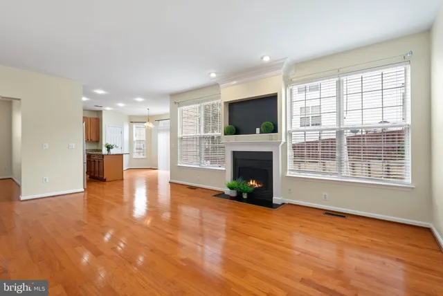 a view of empty room with a fireplace and window