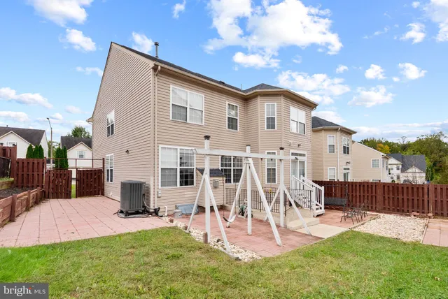 a view of a house with a yard patio and a slide
