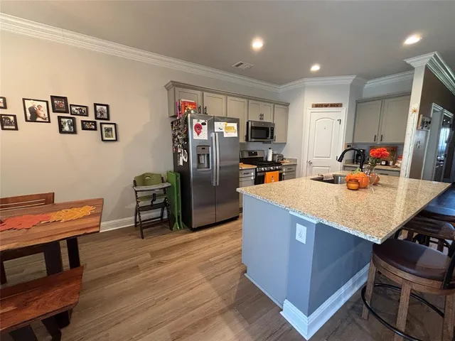 a view of kitchen with cabinets and wooden floor