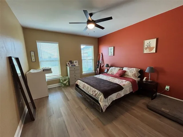 a bedroom with a bed dresser and a window