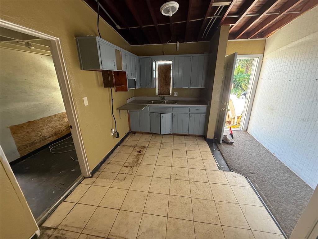 918 Ferndell Road Orlando, FL 32808 - Photo 4 of 8 a bathroom with a sink a mirror and a shower