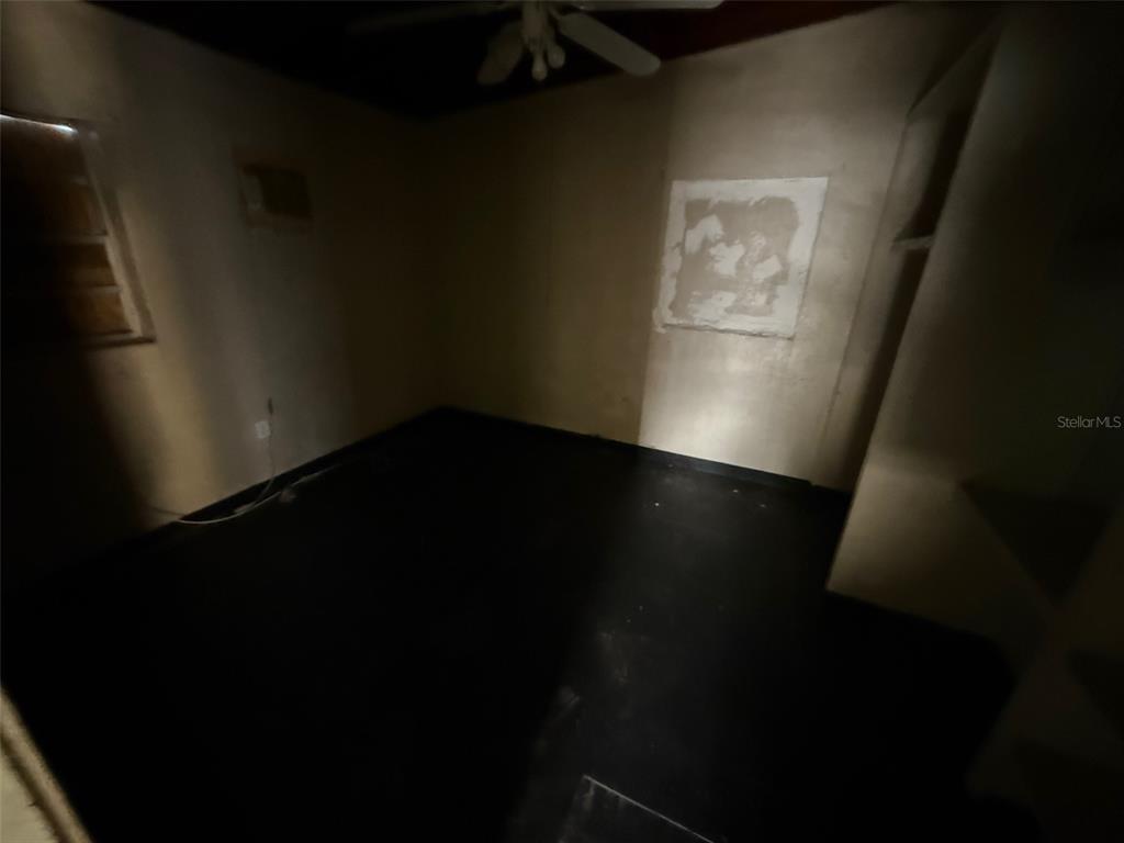 918 Ferndell Road Orlando, FL 32808 - Photo 6 of 8 a view of an empty room and wooden floor