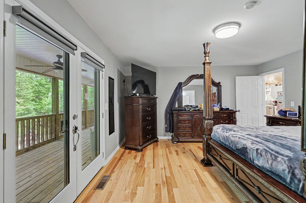 522 Fred Amos Road Murphy, NC 28906 - Photo 55 of 73 a bedroom with a bed and wooden floor