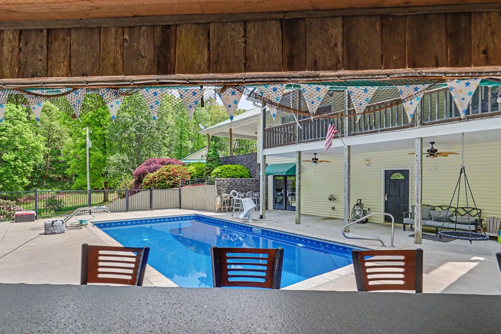 522 Fred Amos Road Murphy, NC 28906 - Photo 6 of 73 a swimming pool with outdoor seating and wooden fence