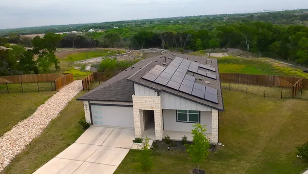 a aerial view of a house with pool