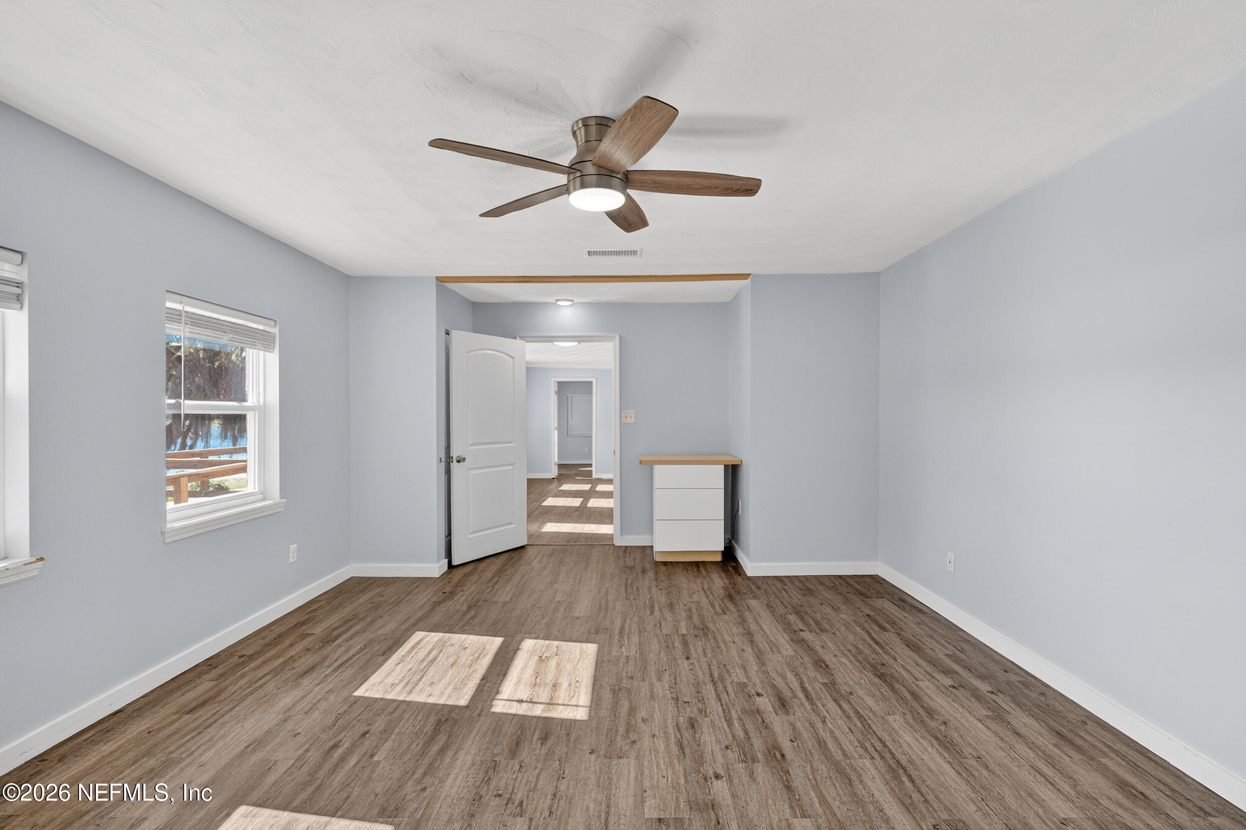 228 Southeast 66th Street Starke, FL 32091 - Photo 11 of 39 a view of empty room with wooden floor and fan