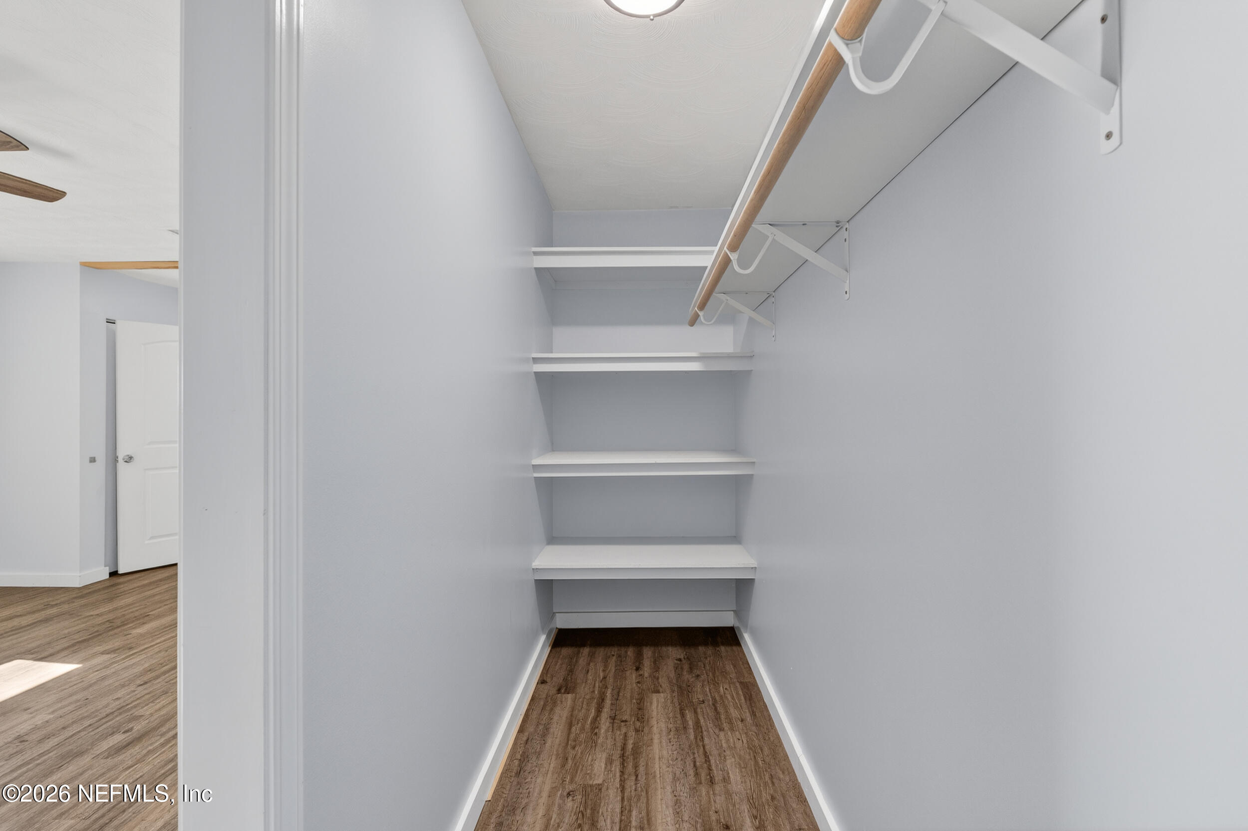 228 Southeast 66th Street Starke, FL 32091 - Photo 14 of 39 a walk in closet with wooden floor