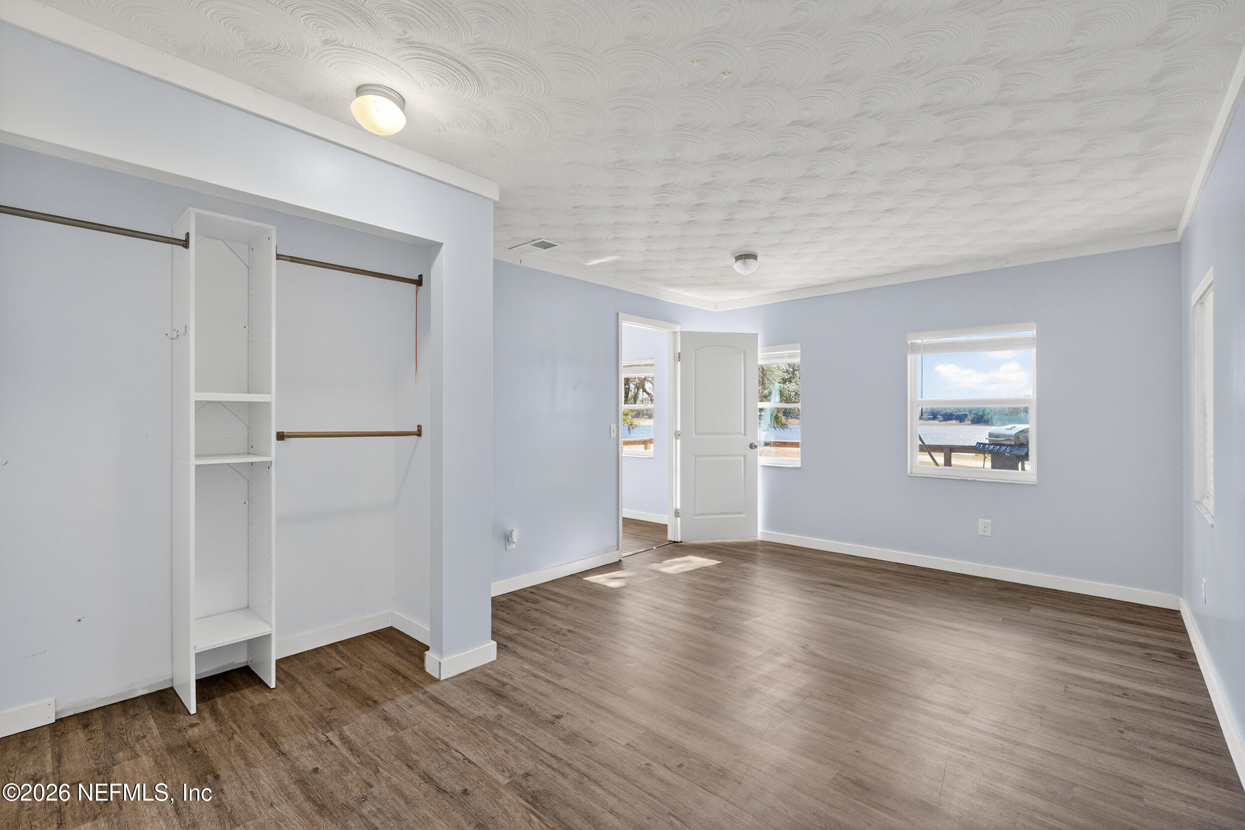 228 Southeast 66th Street Starke, FL 32091 - Photo 20 of 39 an empty room with wooden floor & windows