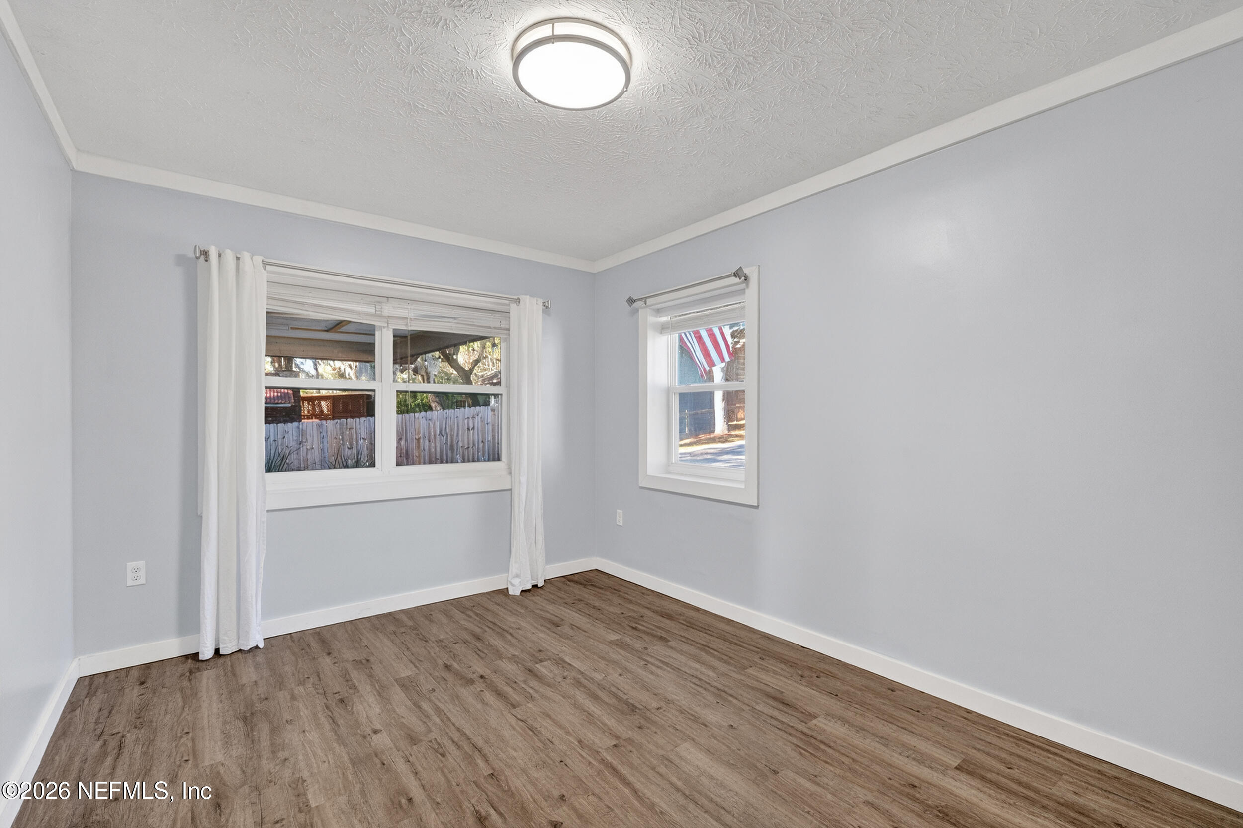 228 Southeast 66th Street Starke, FL 32091 - Photo 21 of 39 an empty room with wooden floor and windows