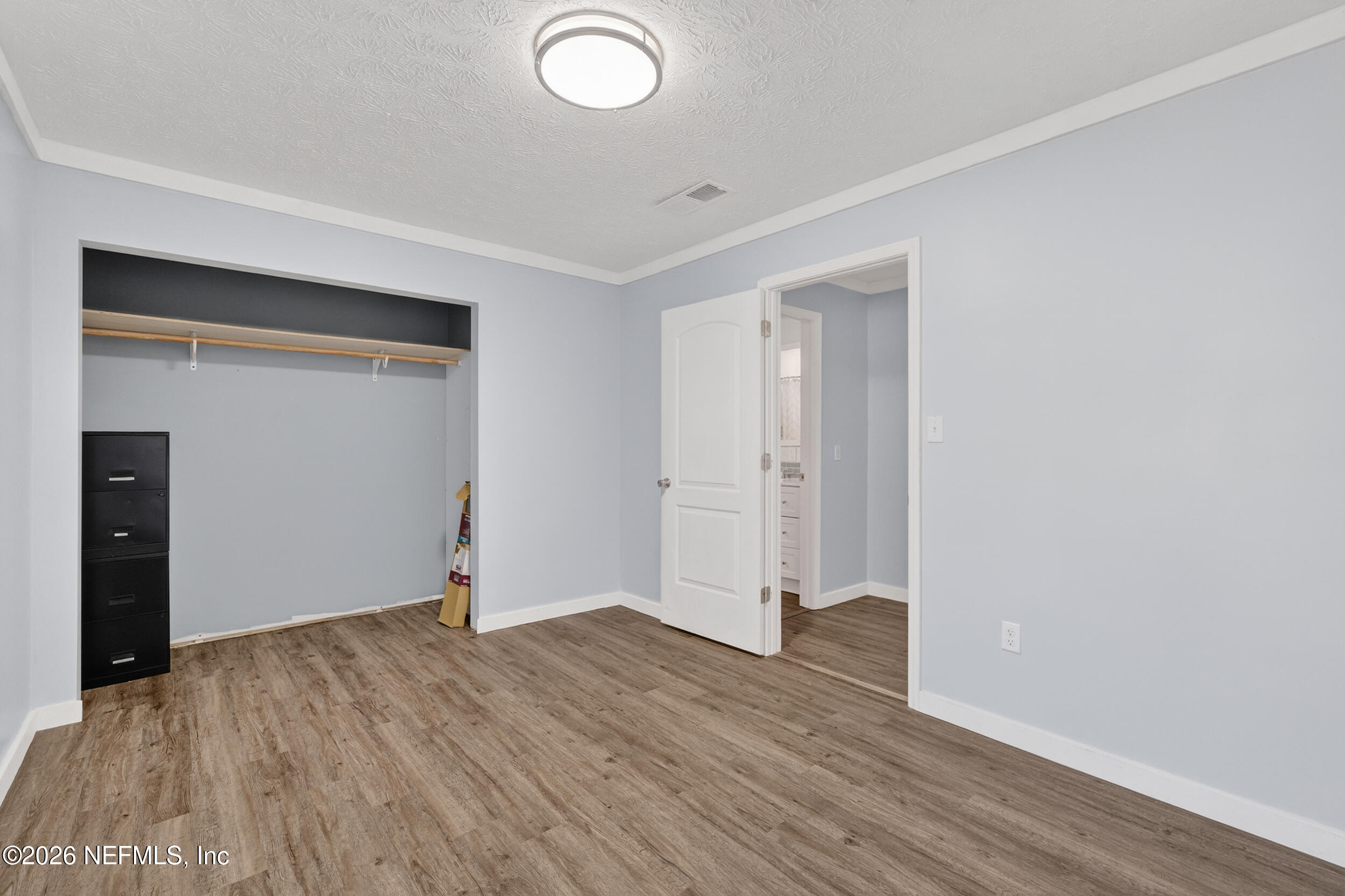 228 Southeast 66th Street Starke, FL 32091 - Photo 22 of 39 an empty room with wooden floor and closet