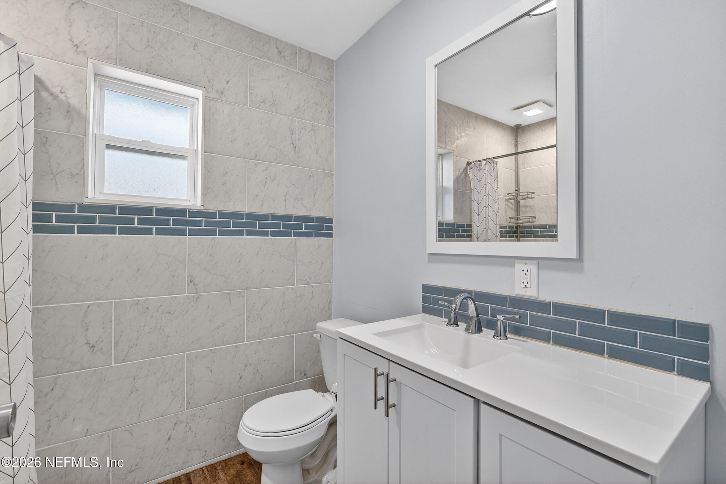 228 Southeast 66th Street Starke, FL 32091 - Photo 23 of 39 a bathroom with a sink toilet vanity and shower