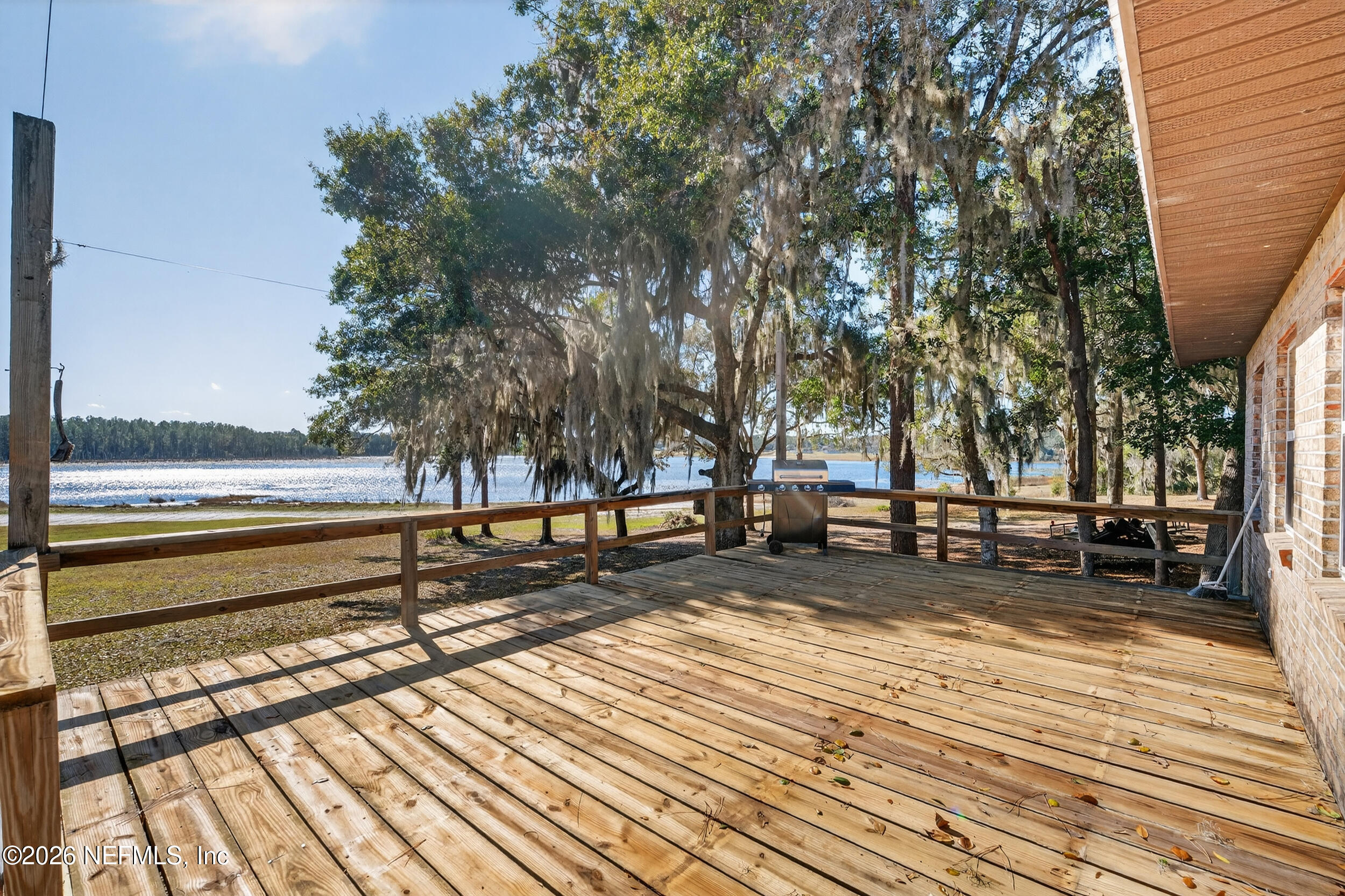 228 Southeast 66th Street Starke, FL 32091 - Photo 28 of 39 a view of a terrace with wooden floor and trees