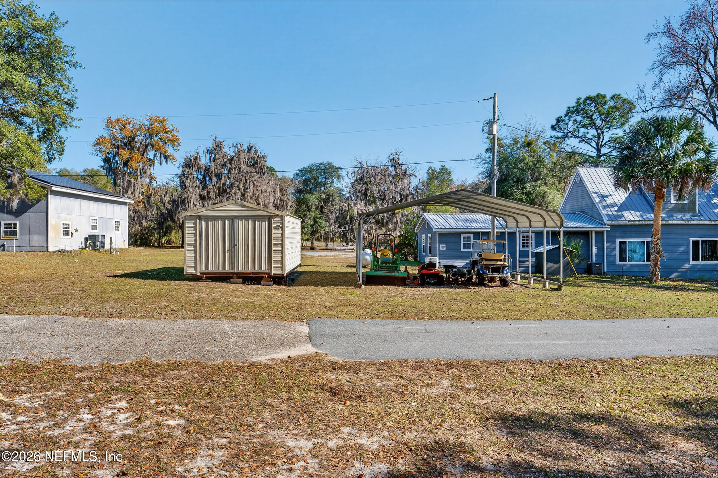 228 Southeast 66th Street Starke, FL 32091 - Photo 31 of 39 a front view of a house with a yard and trees