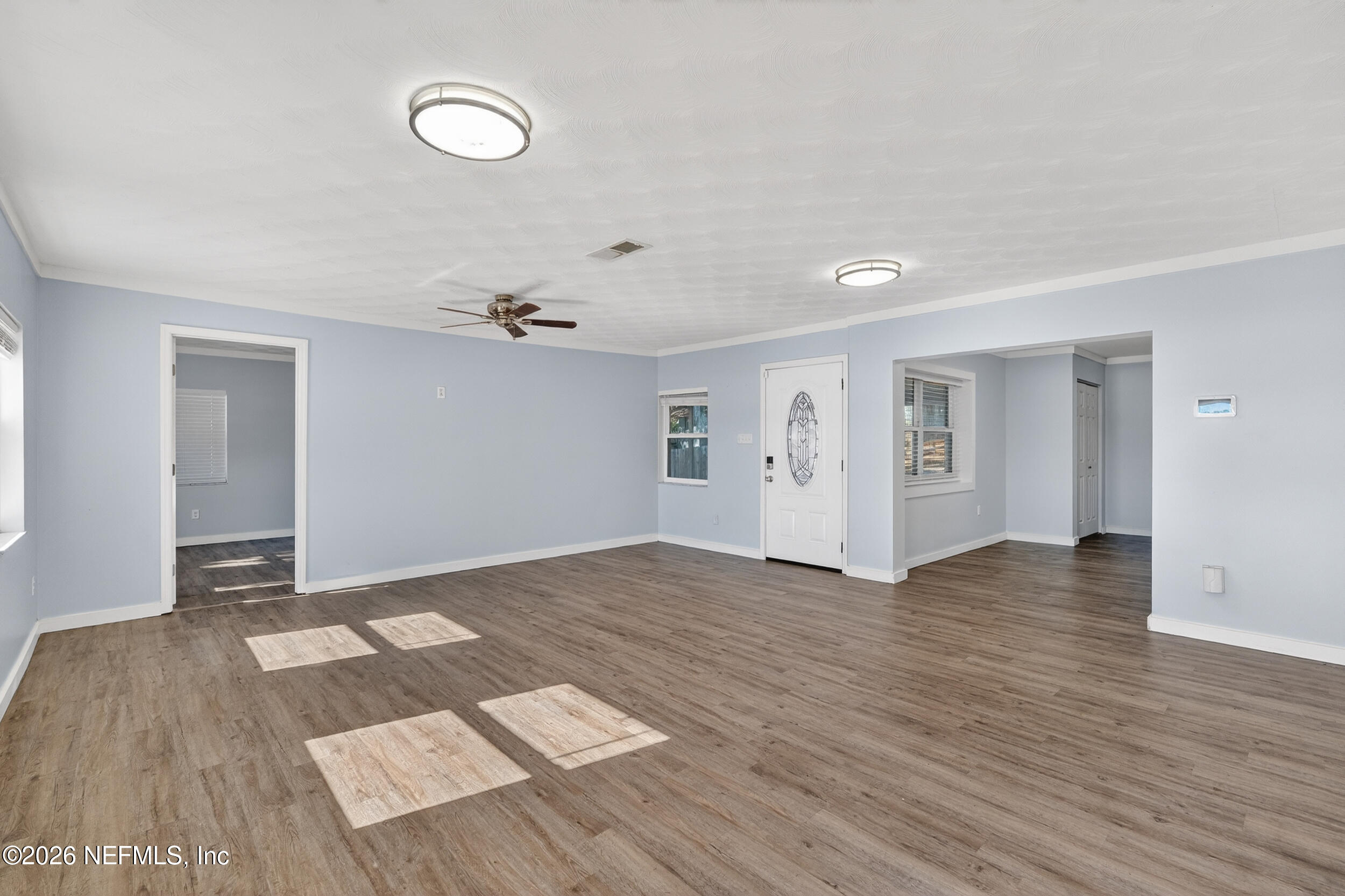 228 Southeast 66th Street Starke, FL 32091 - Photo 5 of 39 wooden floor in an empty room with a window