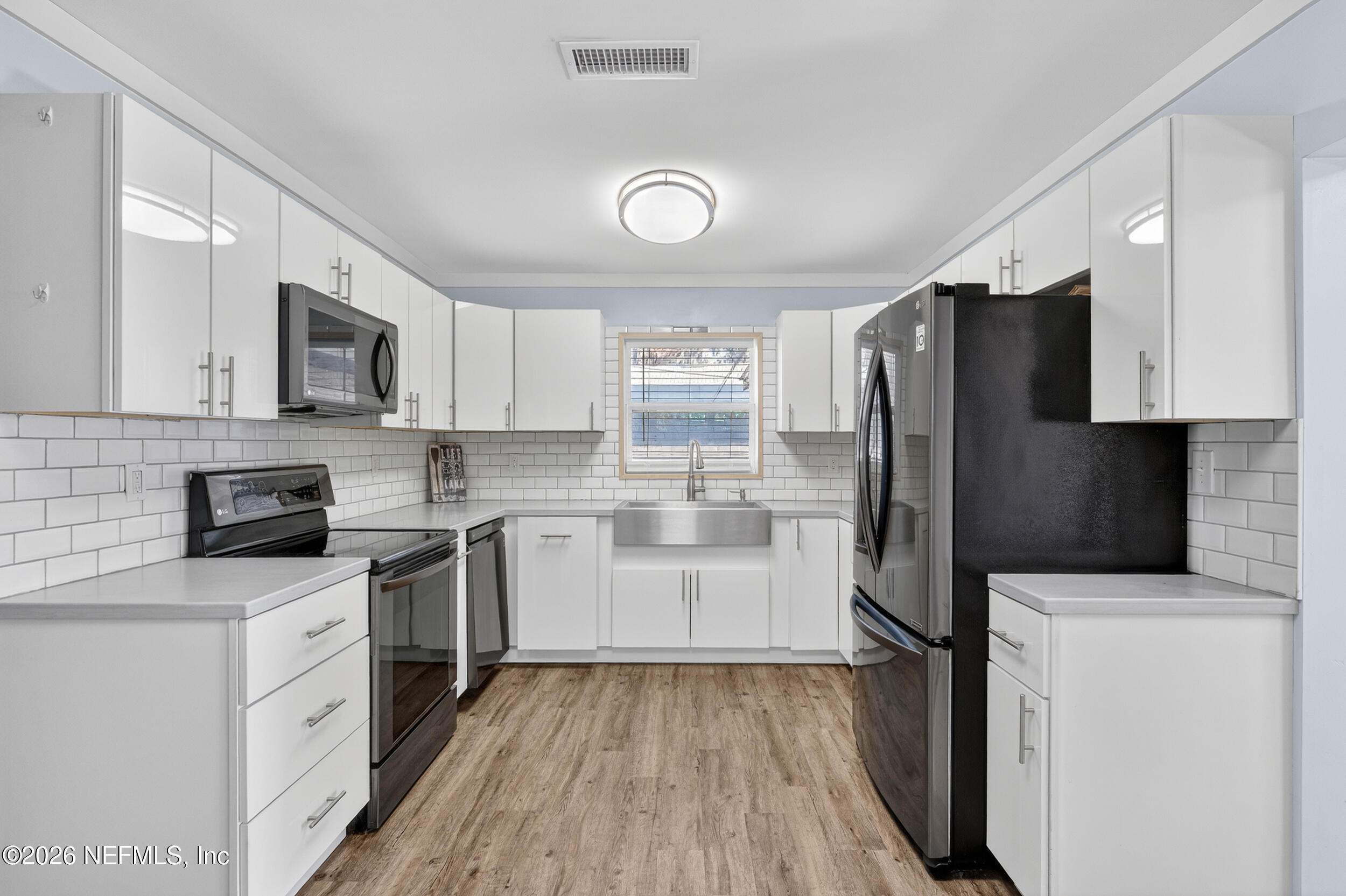 228 Southeast 66th Street Starke, FL 32091 - Photo 6 of 39 a kitchen with a refrigerator stove and microwave