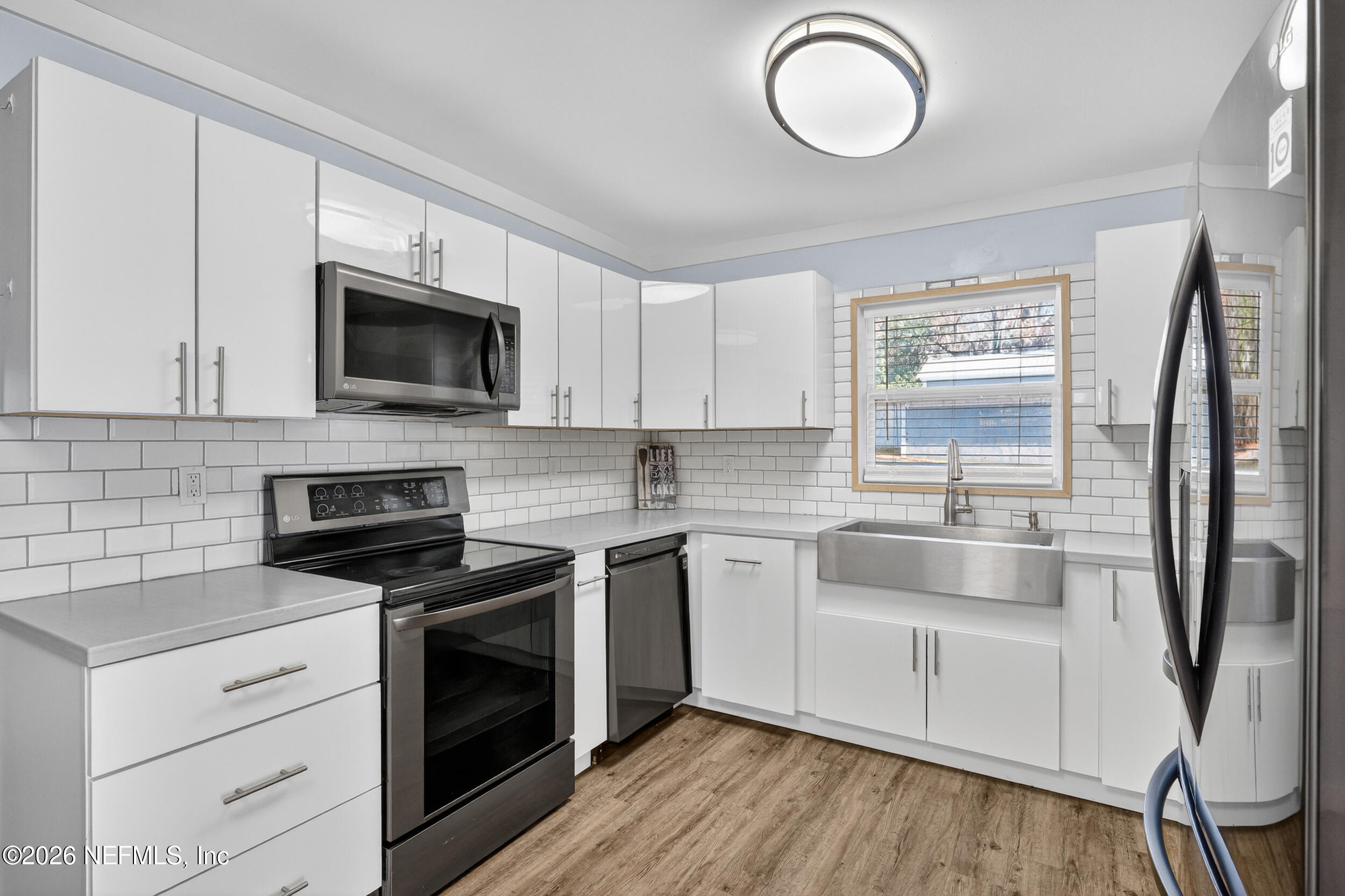 228 Southeast 66th Street Starke, FL 32091 - Photo 7 of 39 a kitchen with a sink stove and microwave