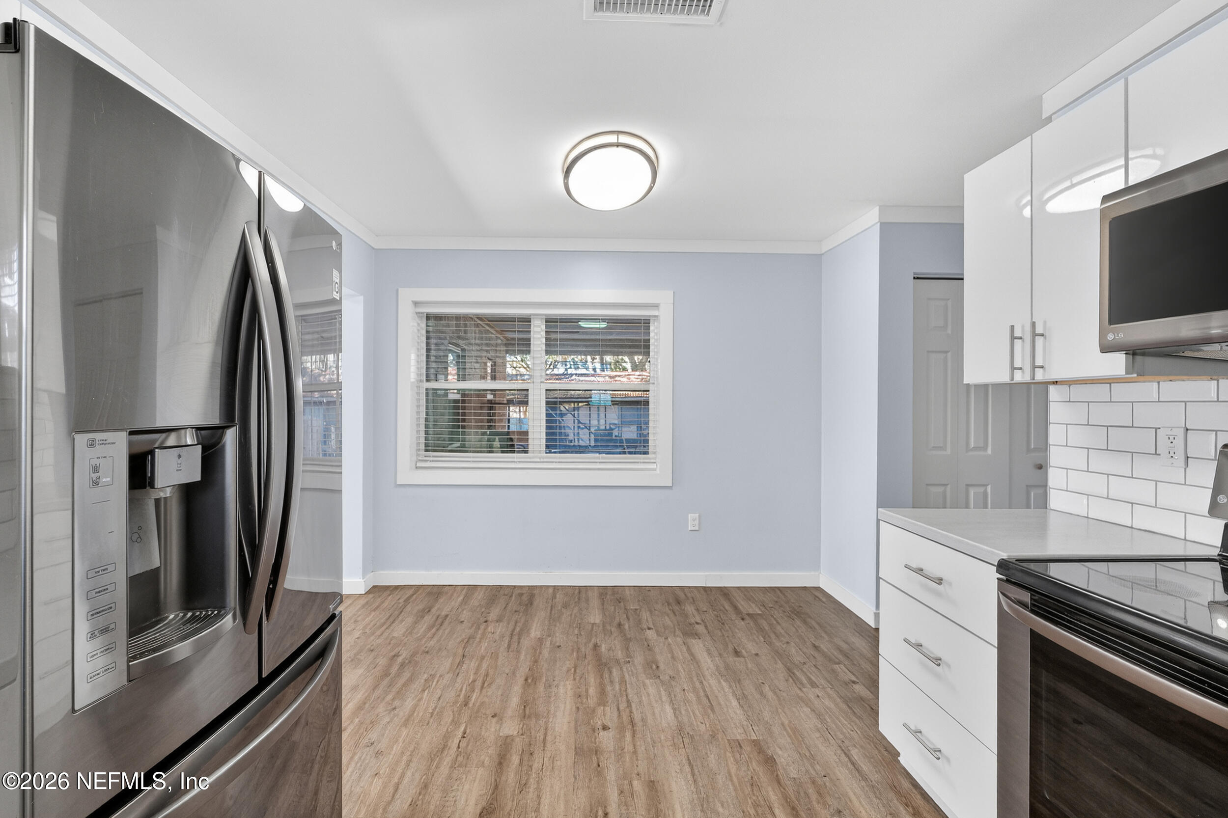 228 Southeast 66th Street Starke, FL 32091 - Photo 8 of 39 a kitchen with stainless steel appliances granite countertop a refrigerator and a stove top oven
