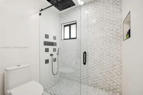 a bathroom with a toilet and shower