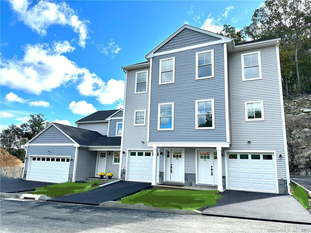 85 River (aka Spindrift) Road, Unit 31 Shelton, CT 06484 - Photo 1 of 1 a front view of a house with a garden