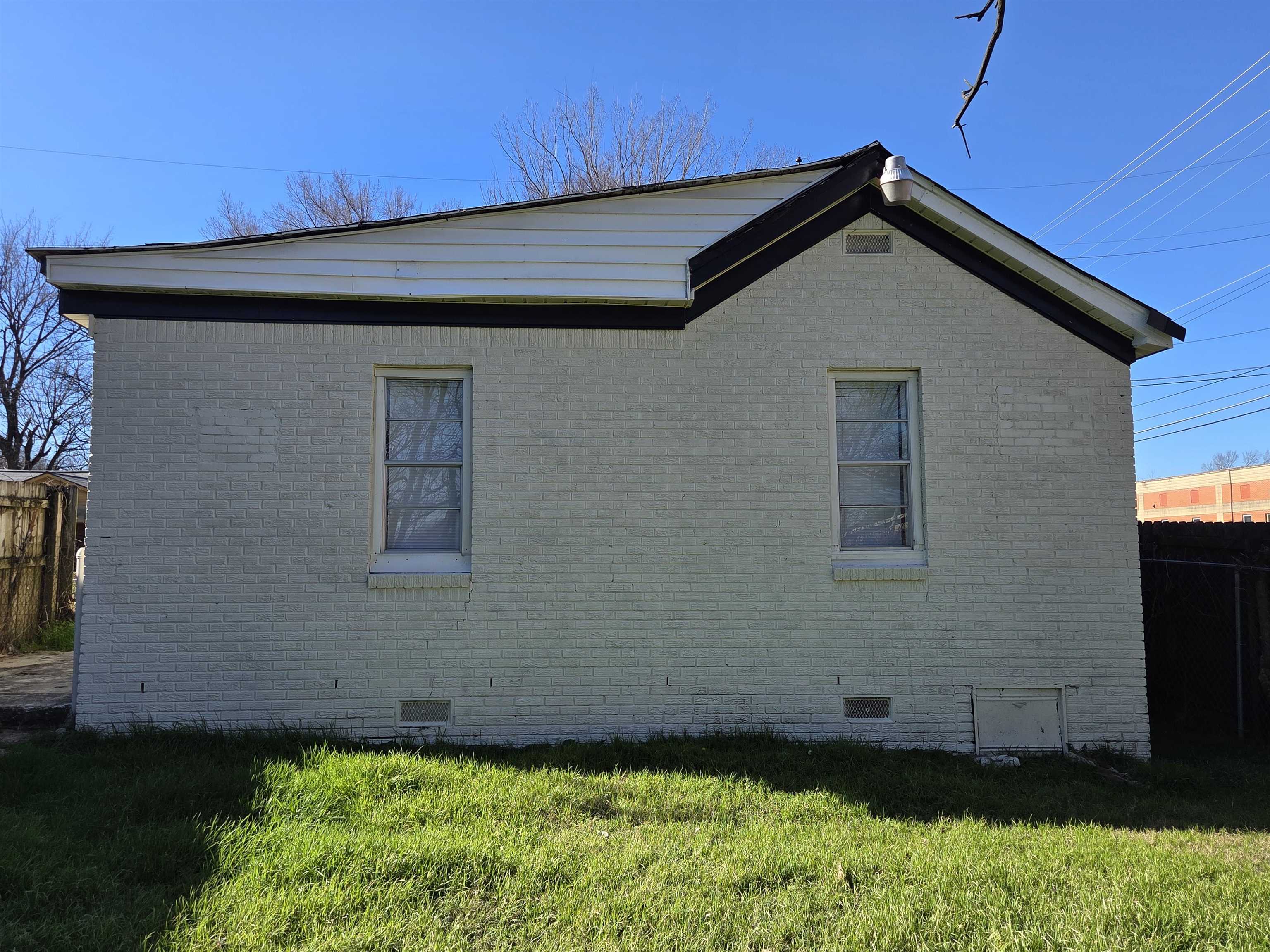 1558 Tayner Street Memphis, TN 38108 - Photo 4 of 12 a front view of a house with a yard