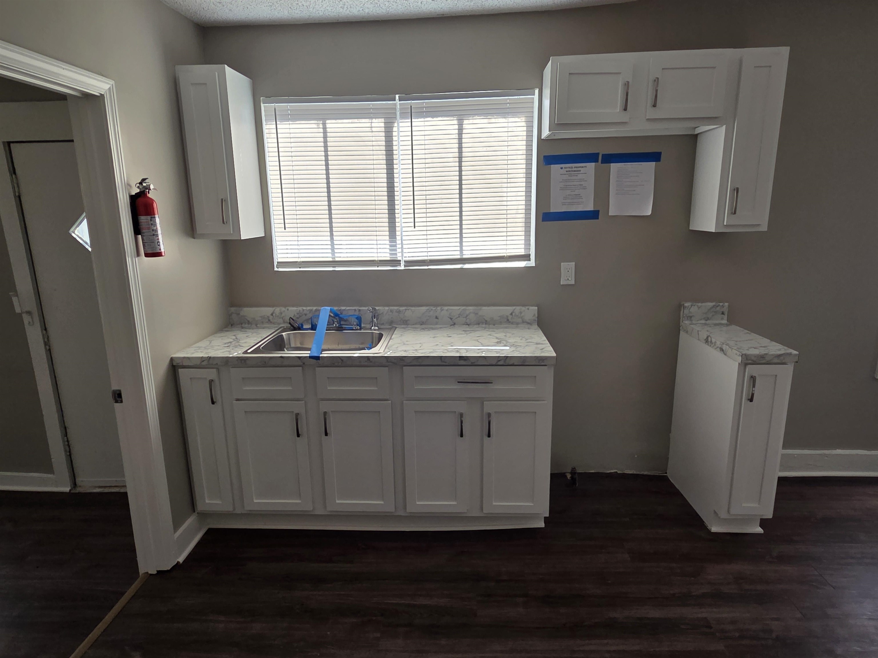 1558 Tayner Street Memphis, TN 38108 - Photo 5 of 12 a bathroom with a granite countertop sink and a mirror