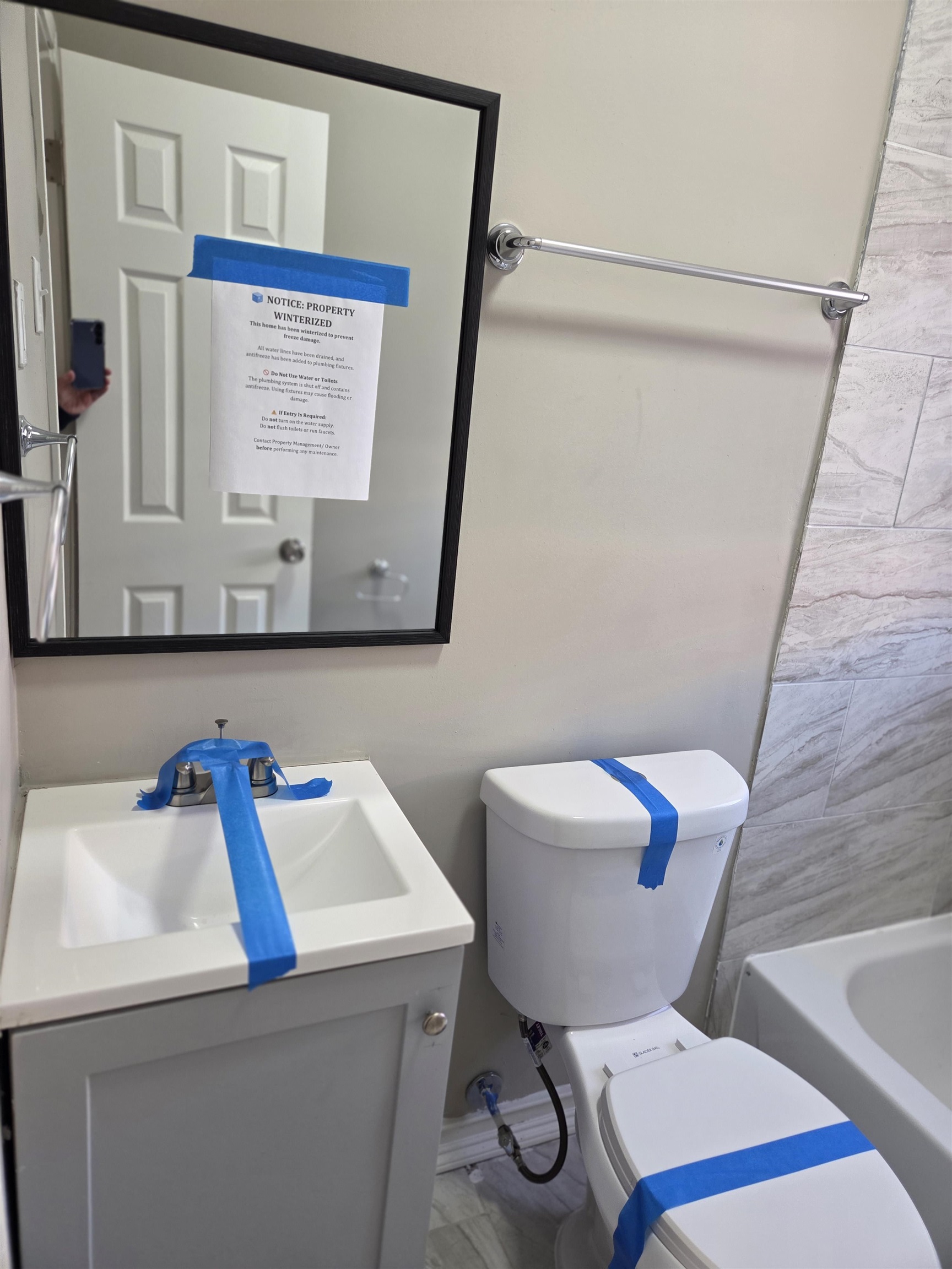 1558 Tayner Street Memphis, TN 38108 - Photo 7 of 12 a bathroom with a toilet sink and mirror