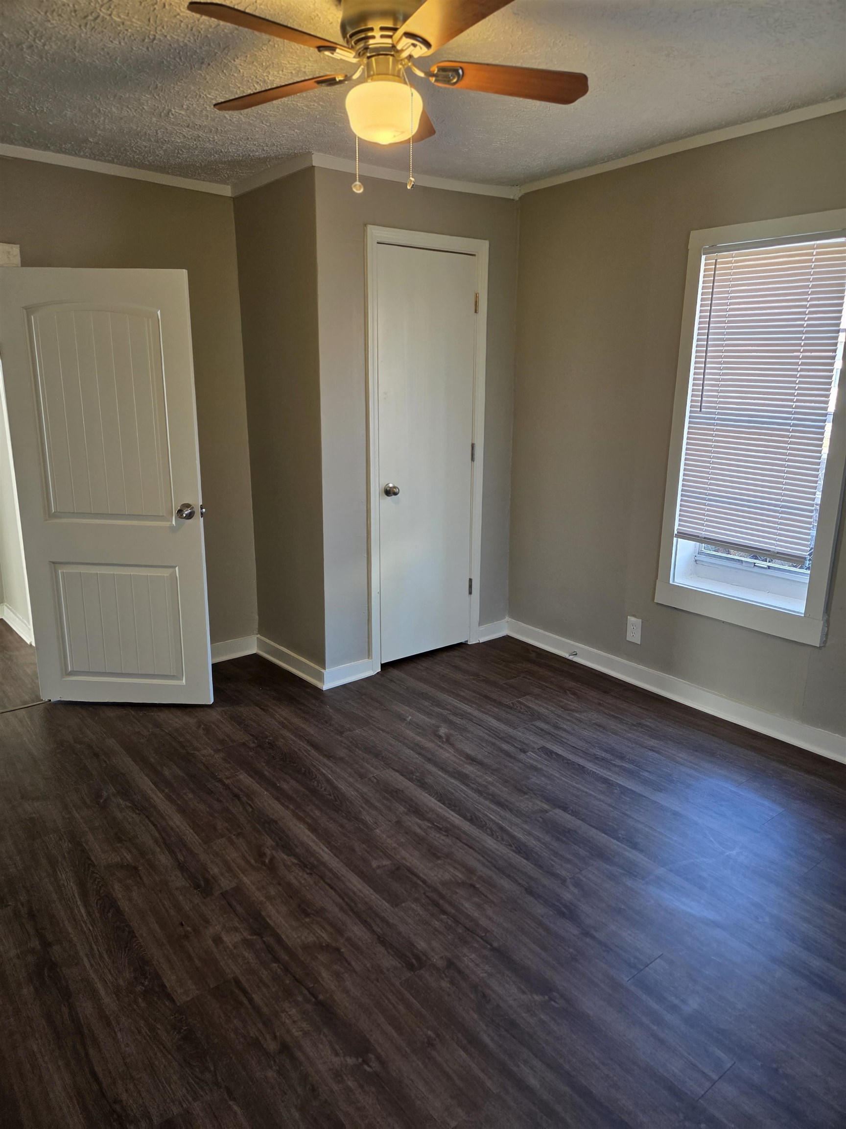 1558 Tayner Street Memphis, TN 38108 - Photo 10 of 12 an empty room with wooden floor fan and windows