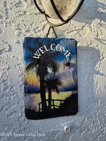 a living room with a couch and a refrigerator