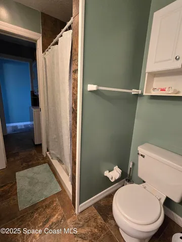 a kitchen with a sink and a stove top oven with wooden floor