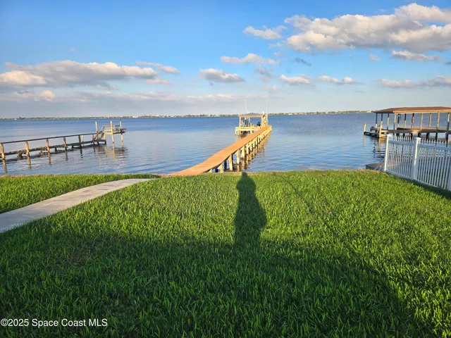 a kitchen with stainless steel appliances a sink a stove a microwave a sink a refrigerator and cabinets
