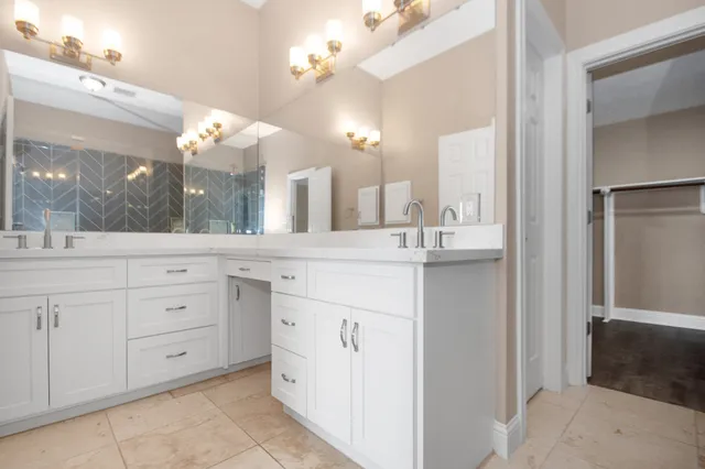 a bathroom with a double vanity sink and a mirror