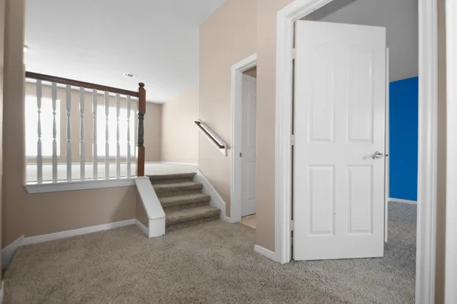 a view of staircase with white walls and windows