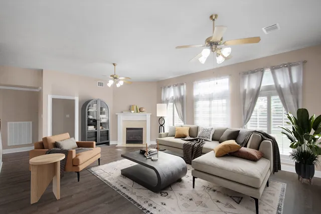 a living room with furniture potted plant and a chandelier