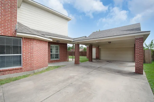 a front view of a house with a garage and glass door