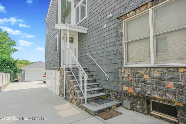 a front view of a house with large windows