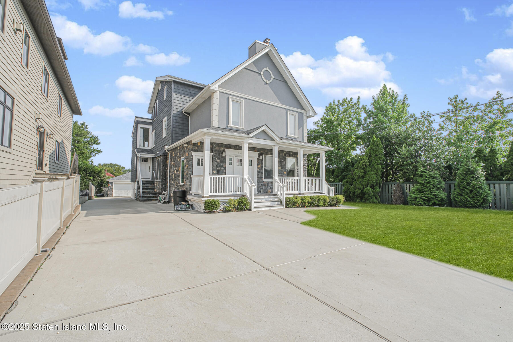 5434 Amboy Road Staten Island, NY 10312 - Photo 12 of 51 a view of a white house with a yard and potted plants