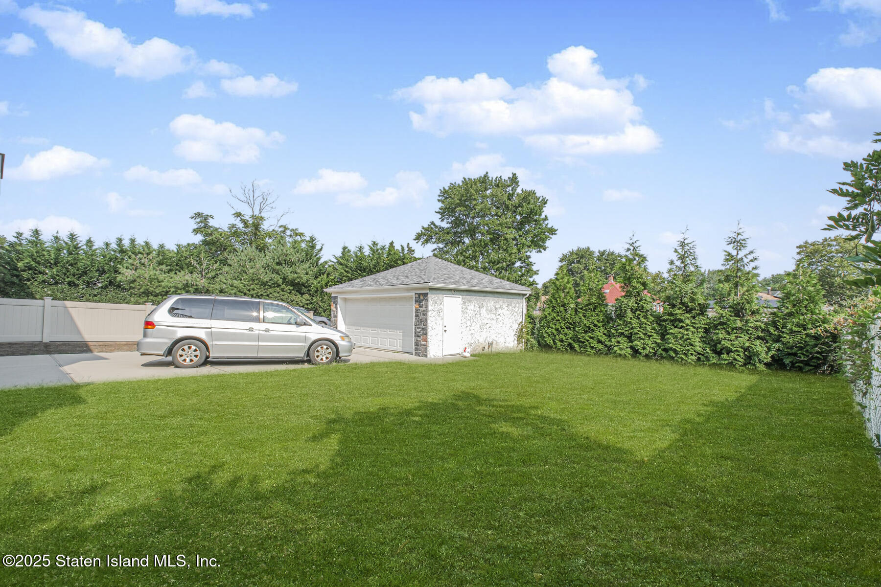 5434 Amboy Road Staten Island, NY 10312 - Photo 13 of 51 a white house with a big yard and large trees