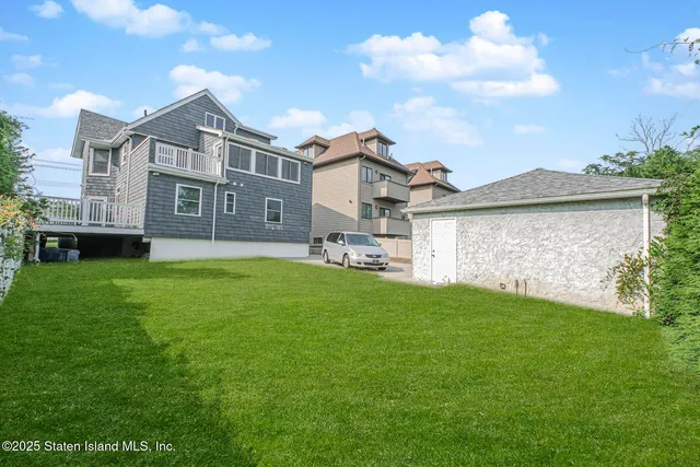 a front view of a house with a garden and yard