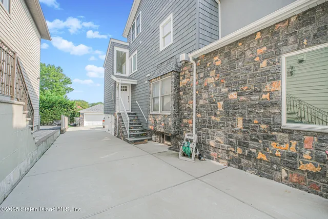 a view of a brick house with many windows