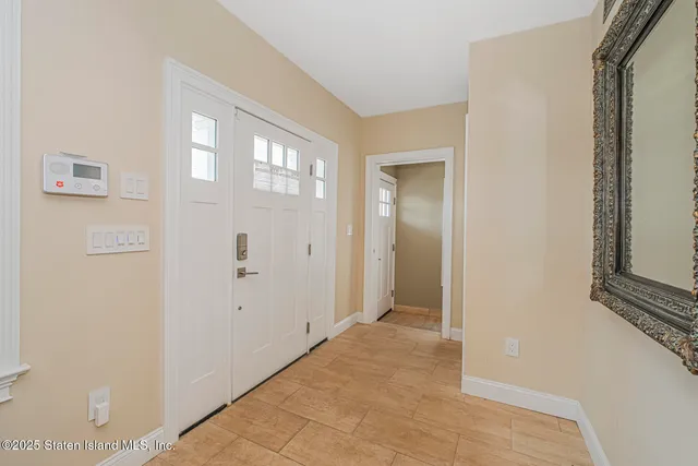 a view of a hallway with wooden floor and a living room