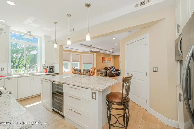 a kitchen with a sink a counter space appliances and cabinets