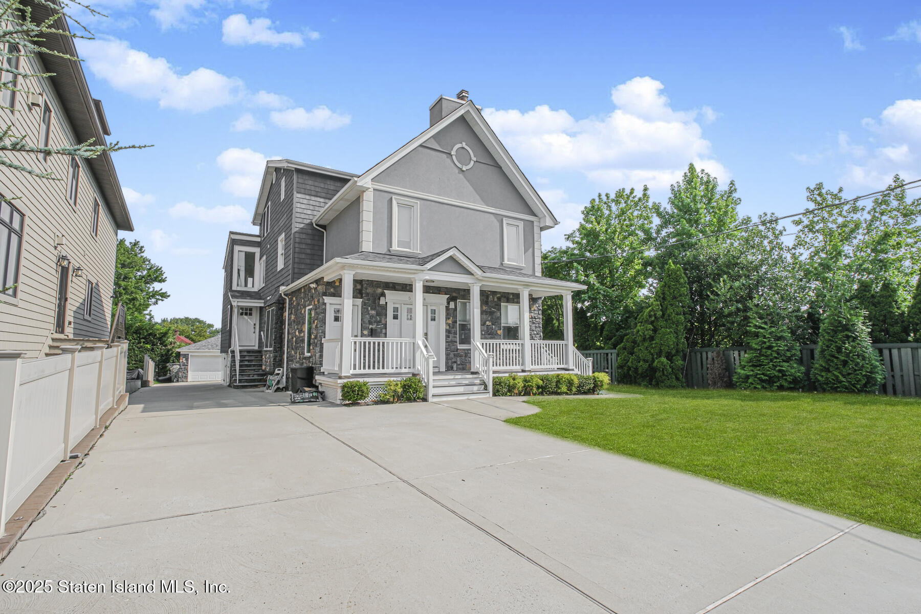 5434 Amboy Road Staten Island, NY 10312 - Photo 2 of 51 a view of a white house with a yard and sitting area