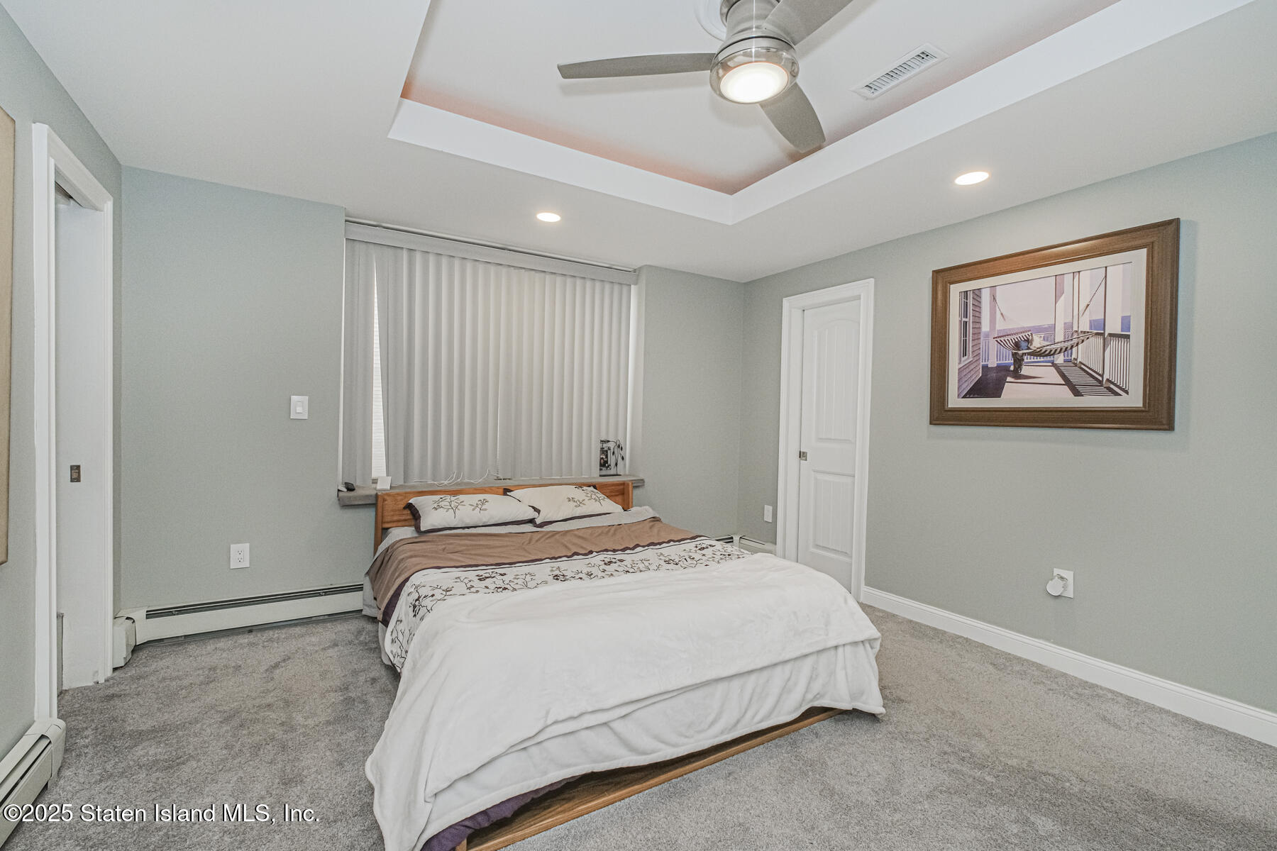 5434 Amboy Road Staten Island, NY 10312 - Photo 22 of 51 a spacious bedroom with a bed and a painting on the wall