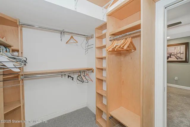 a view of walk in closet with empty racks