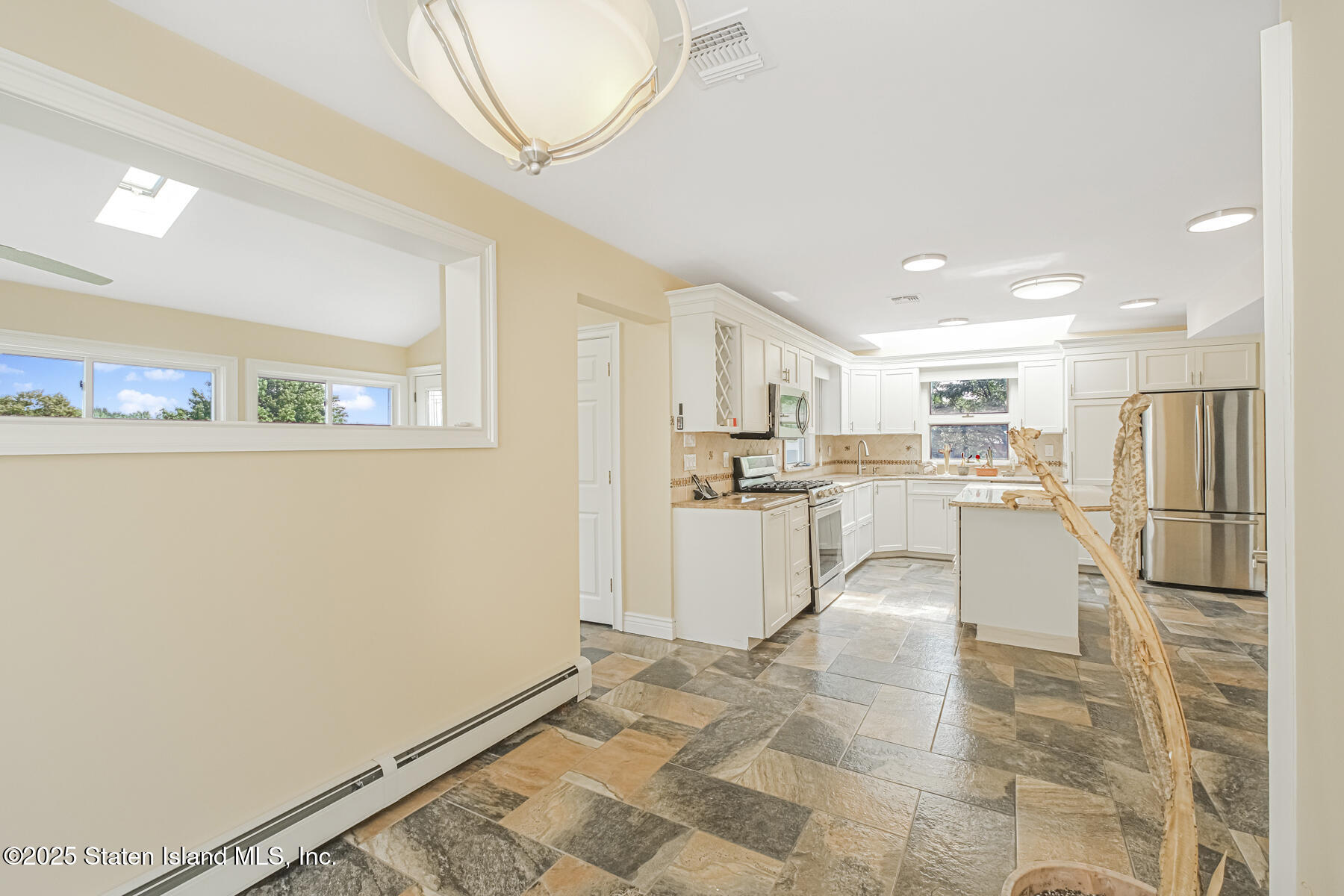 5434 Amboy Road Staten Island, NY 10312 - Photo 28 of 51 a kitchen with white cabinets and refrigerator