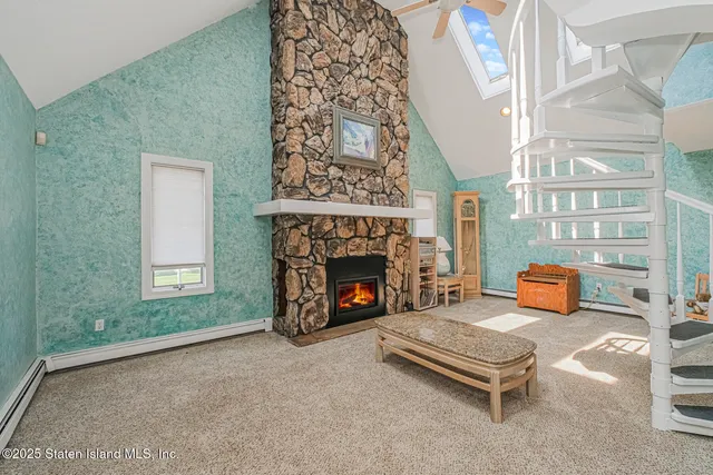 an outdoor living room with furniture and a fireplace