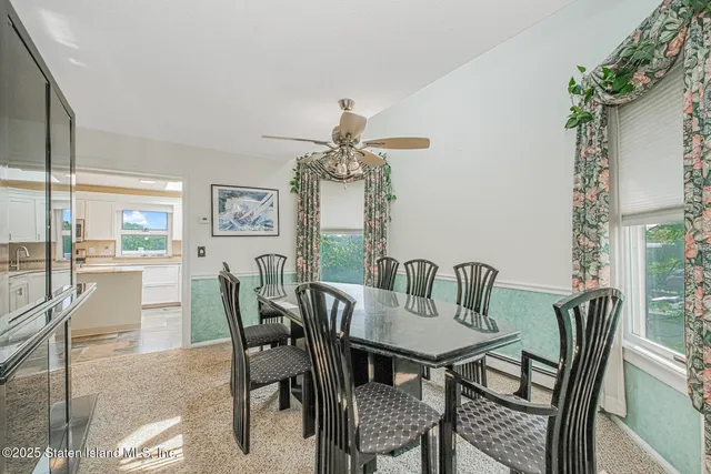 a dining room with furniture a chandelier and wooden floor